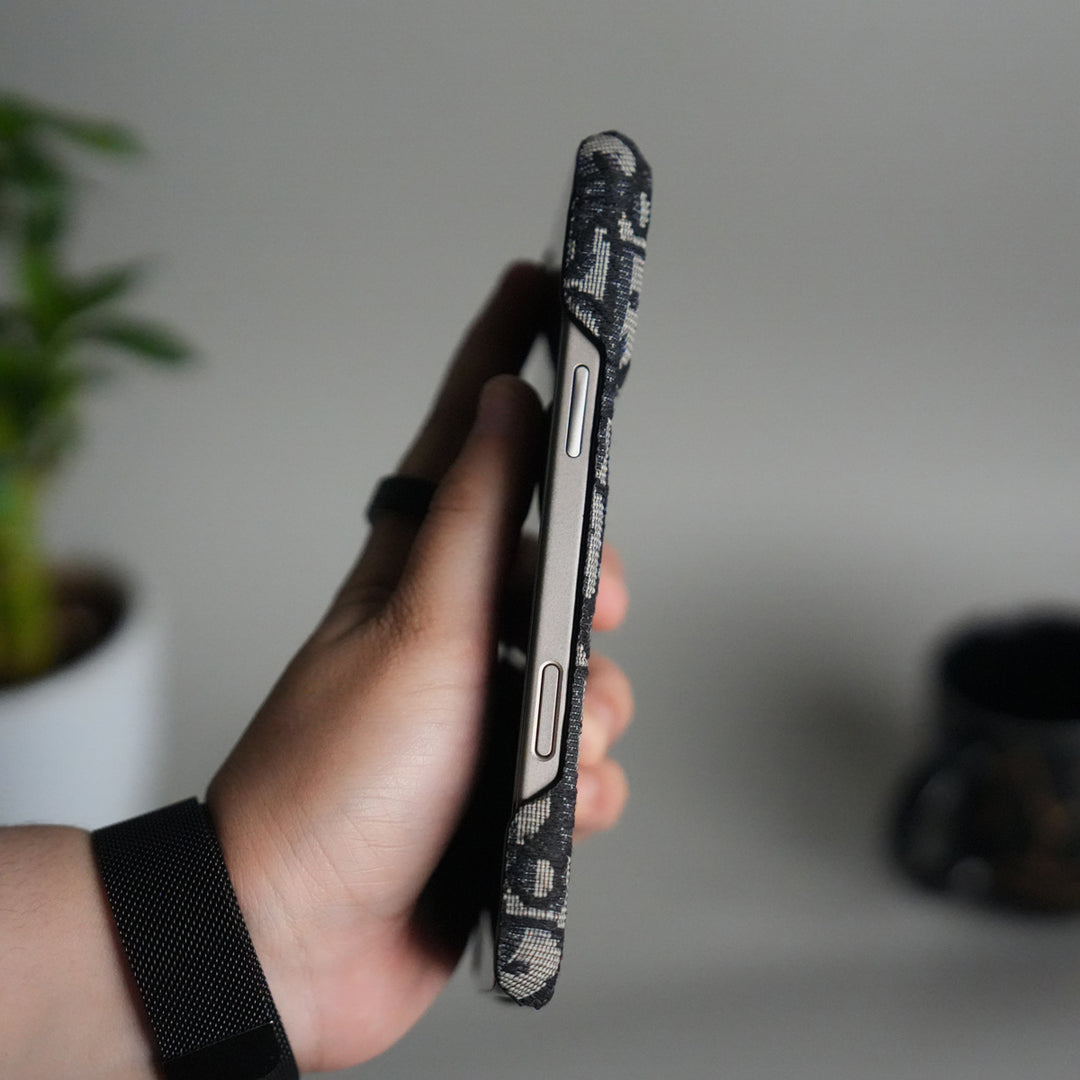 Dior-inspired patterned iPhone case close-up