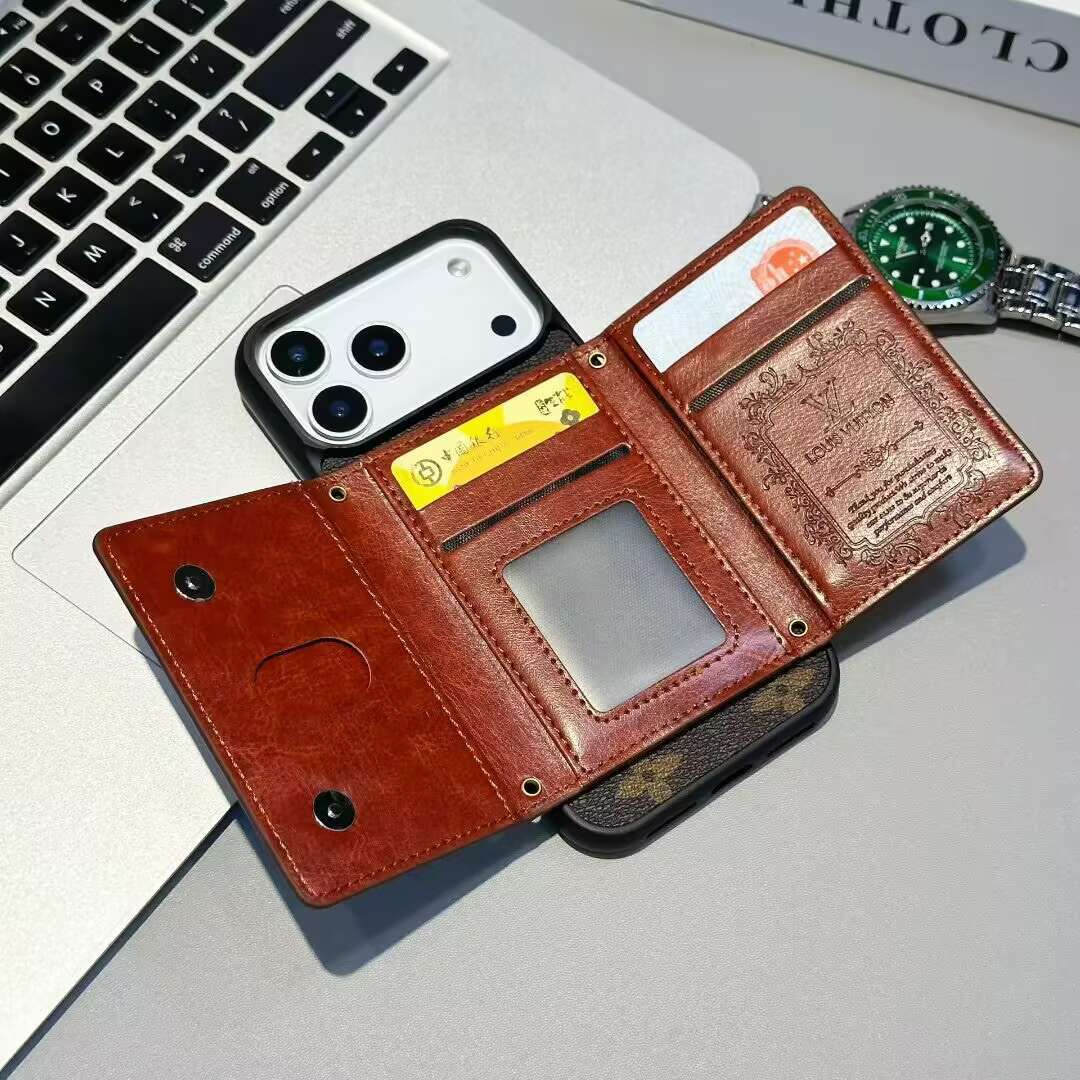 Brown leather wallet with phone and cards on a laptop keyboard