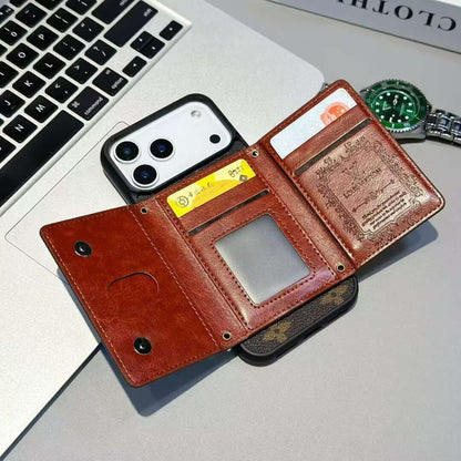 Brown leather wallet with phone and cards on a laptop keyboard