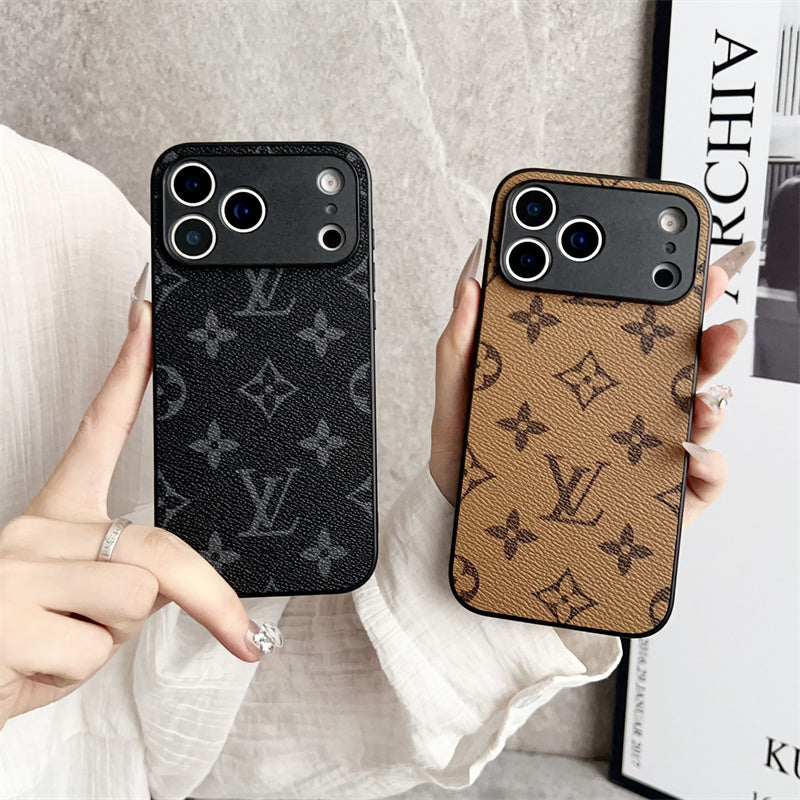 Two phone cases with a monogram pattern held by hands against a neutral background.